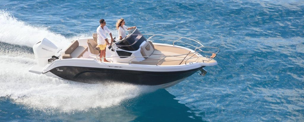 Ranieri Next 220 SH blasting across the blue ocean with a glamorous couple onboard
